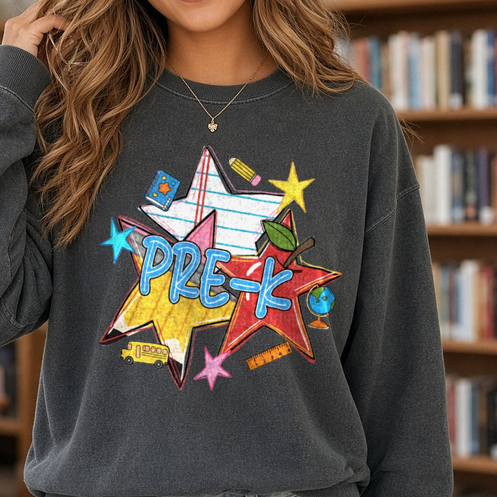 Pre-K Bold Star Burst School Supplies Back to School Design DTF transfer shown on a Comfort Colors sweatshirt