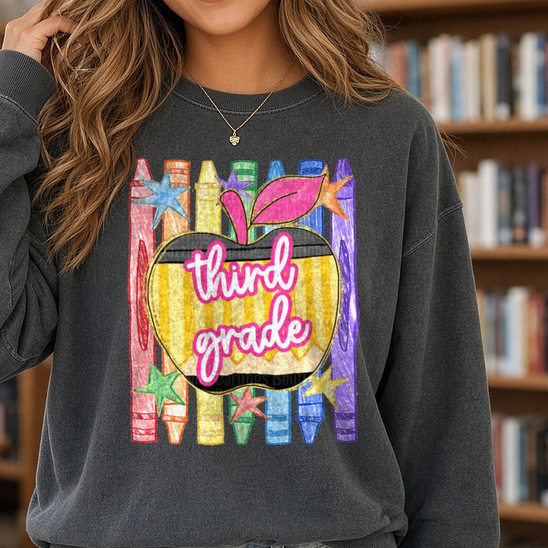 Third Grade Pencil Apple Rainbow Crayons Back to School DTF transfer shown on a Comfort Colors sweatshirt