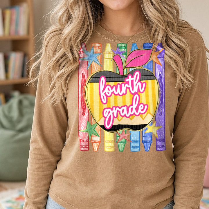 Fourth Grade Pencil Apple Rainbow Crayons Stars Design DTF transfer shown on a Comfort Colors long sleeve tee