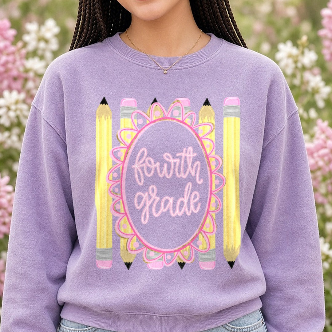 Fourth Grade Pink Floral Oval Frame with Yellow Pencils DTF transfer shown on a Comfort Colors sweatshirt