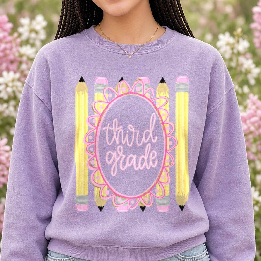 Third Grade Pink Floral Oval Frame with Yellow Pencils DTF transfer shown on a Comfort Colors sweatshirt