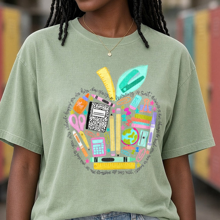 Teacher Apple School Supplies Collage Motivational Quote DTF transfer shown on a Comfort Colors tee