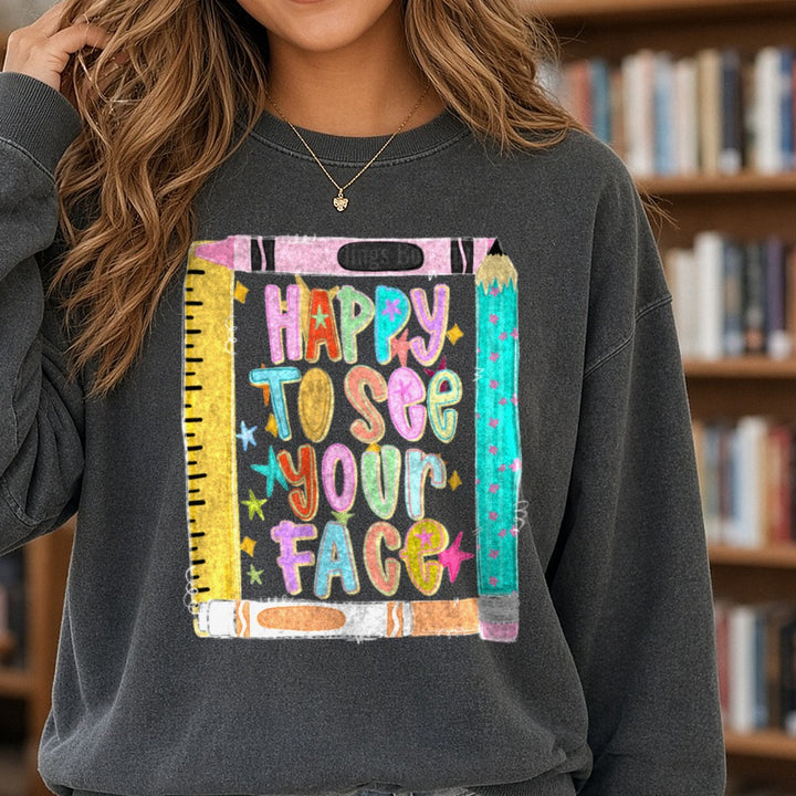 Happy To See Your Face Colorful School Notebook Design DTF transfer shown on a Comfort Colors sweatshirt