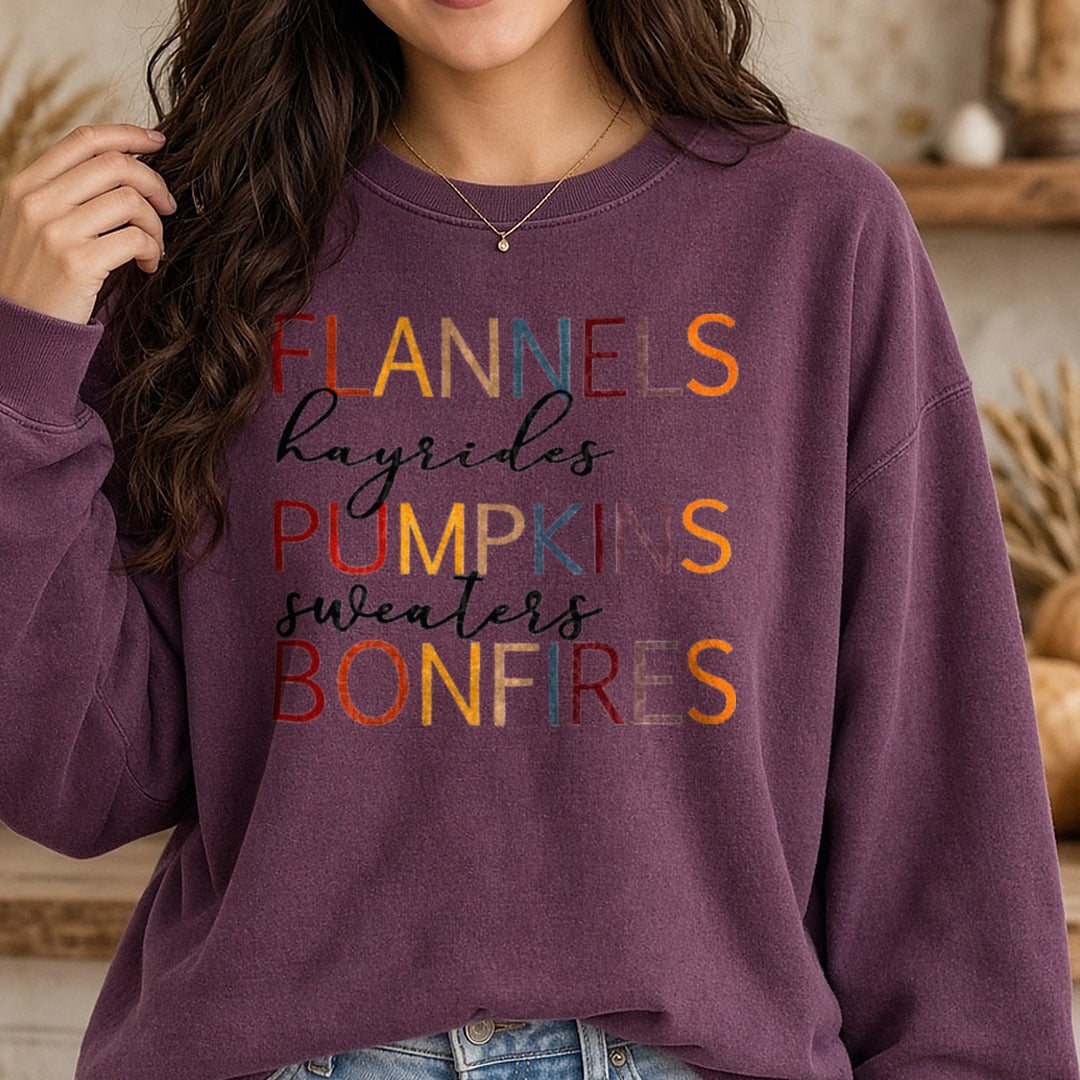 Flannels Hayrides Pumpkins Sweaters Bonfires Fall DTF transfer shown on a Comfort Colors sweatshirt