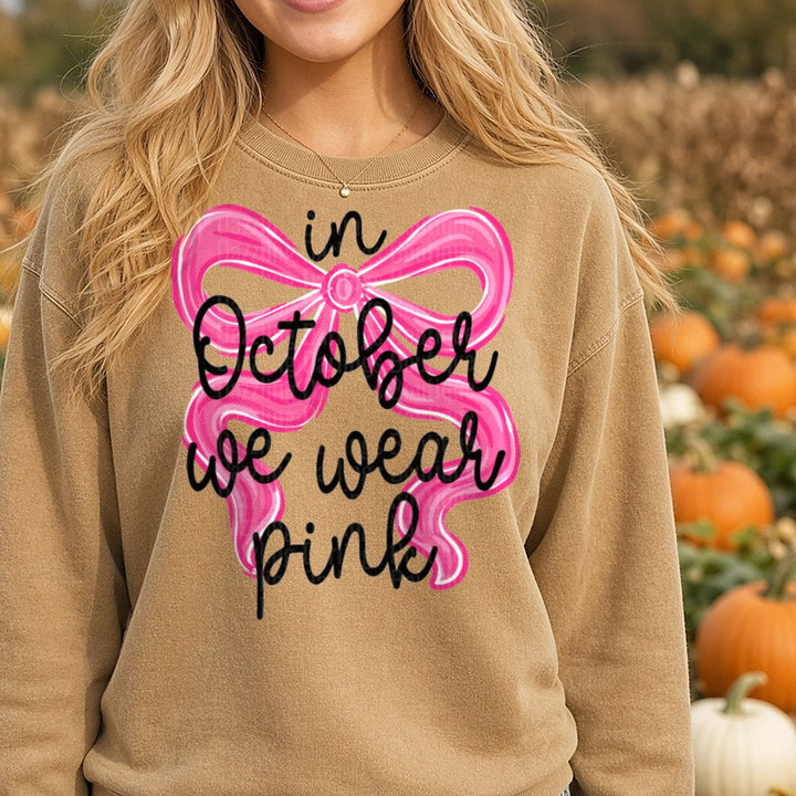 october-we-wear-pink-bow DTF transfer shown on a Comfort Colors sweatshirt