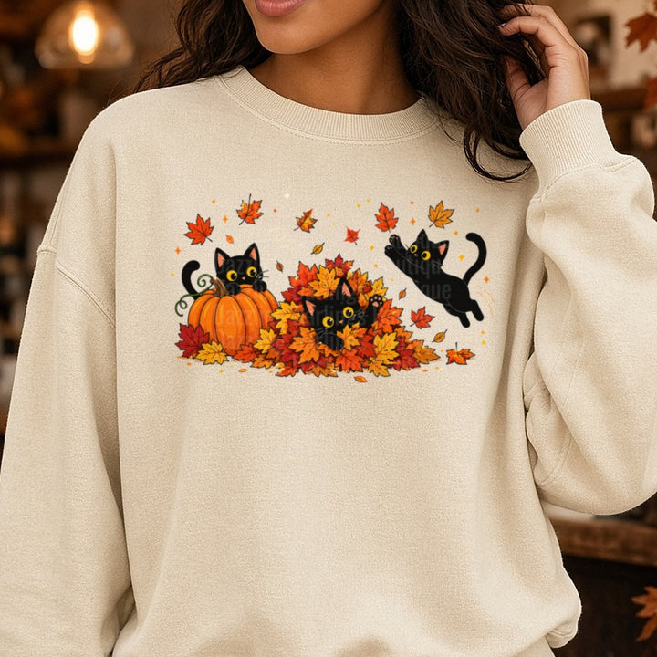 Black Cats Playing in Leaves DTF transfer shown on a Comfort Colors sweatshirt
