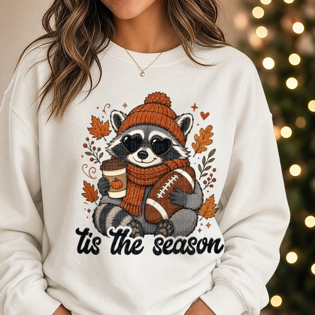 Tis The Season Raccoon DTF transfer shown on a Comfort Colors sweatshirt