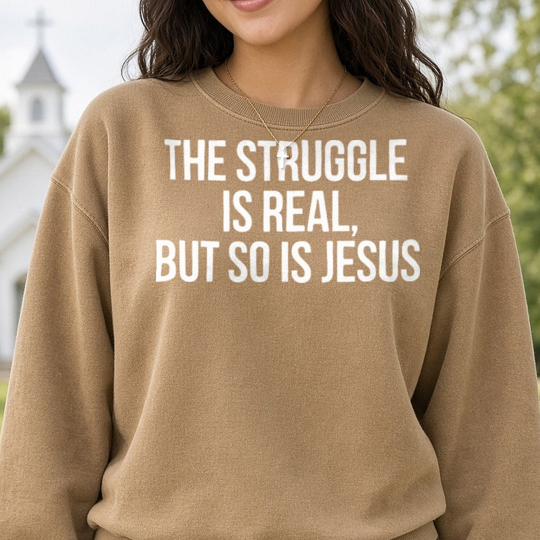 The Struggle Is Real But So Is Jesus DTF transfer shown on a Comfort Colors sweatshirt