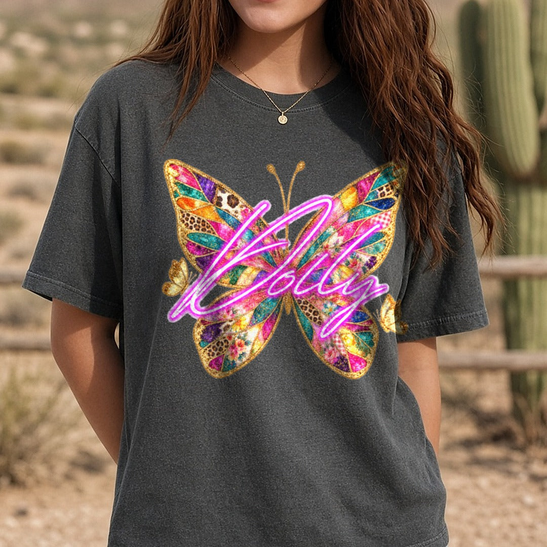 Dolly Neon Script Patchwork Glitter Butterfly Design DTF transfer shown on a Comfort Colors tee