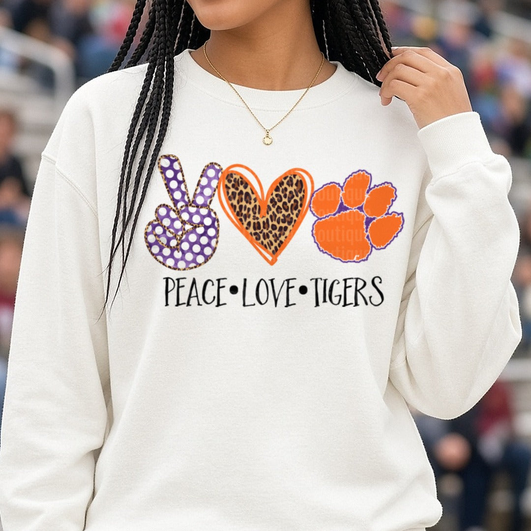 Peace Love Tigers Clemson Paw Purple Orange Leopard Heart DTF transfer shown on a Comfort Colors sweatshirt