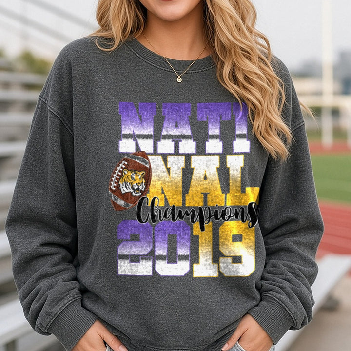 LSU Tigers 2019 National Champions Football Purple Gold DTF transfer shown on a Comfort Colors sweatshirt