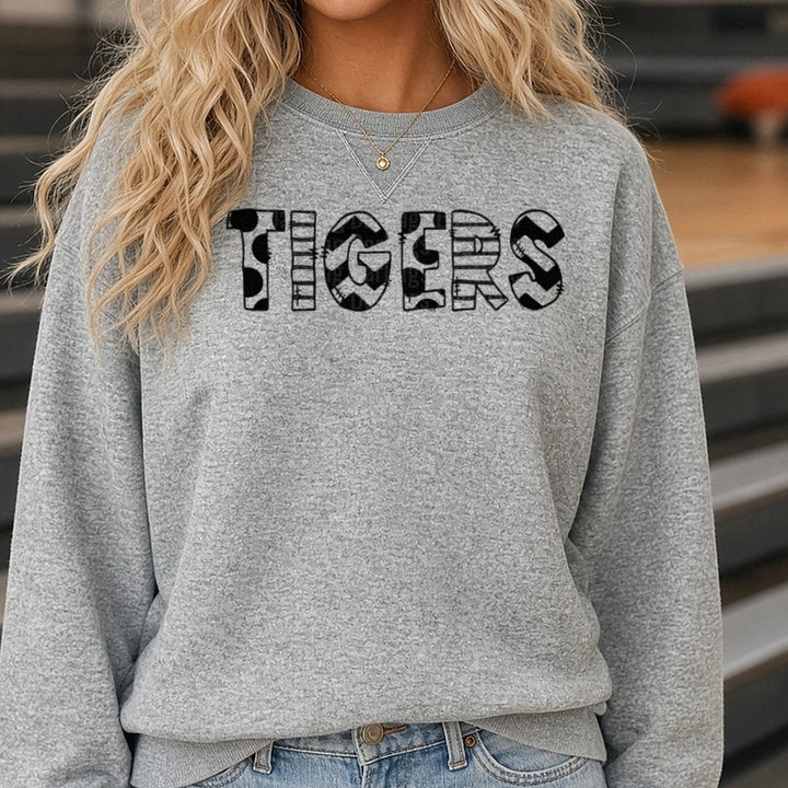 Tigers Mixed Pattern Bold Letters Black White Patchwork DTF transfer shown on a Comfort Colors sweatshirt