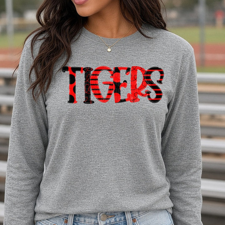 Tigers Red and Black Mixed Pattern Bold Block Letters DTF transfer shown on a Comfort Colors long sleeve tee