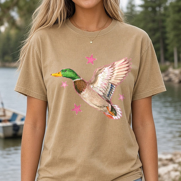 Flying Mallard Duck with Pink Stars Watercolor Art DTF transfer shown on a Comfort Colors tee