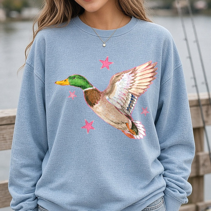 Flying Mallard Duck with Pink Stars Watercolor Art DTF transfer shown on a Comfort Colors sweatshirt