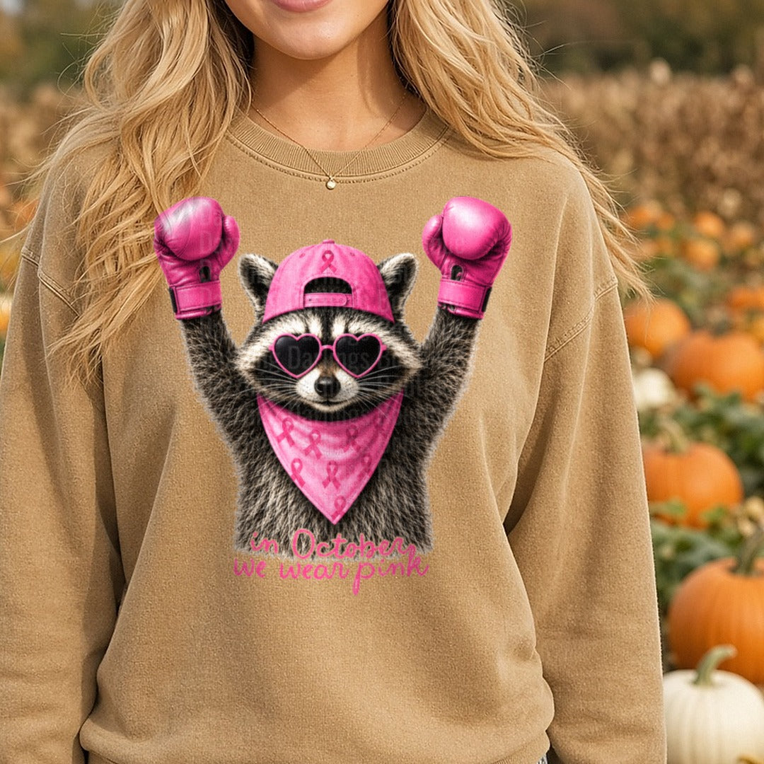 Raccoon Boxing Gloves Pink Ribbon In October We Wear Pink DTF transfer shown on a Comfort Colors sweatshirt