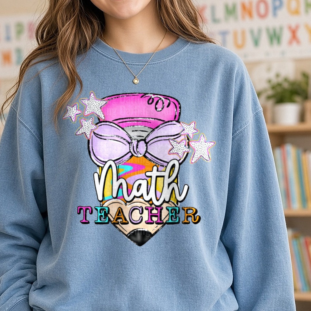 Retro Boho Math Teacher Pencil with Purple Bow and Stars DTF transfer shown on a Comfort Colors sweatshirt