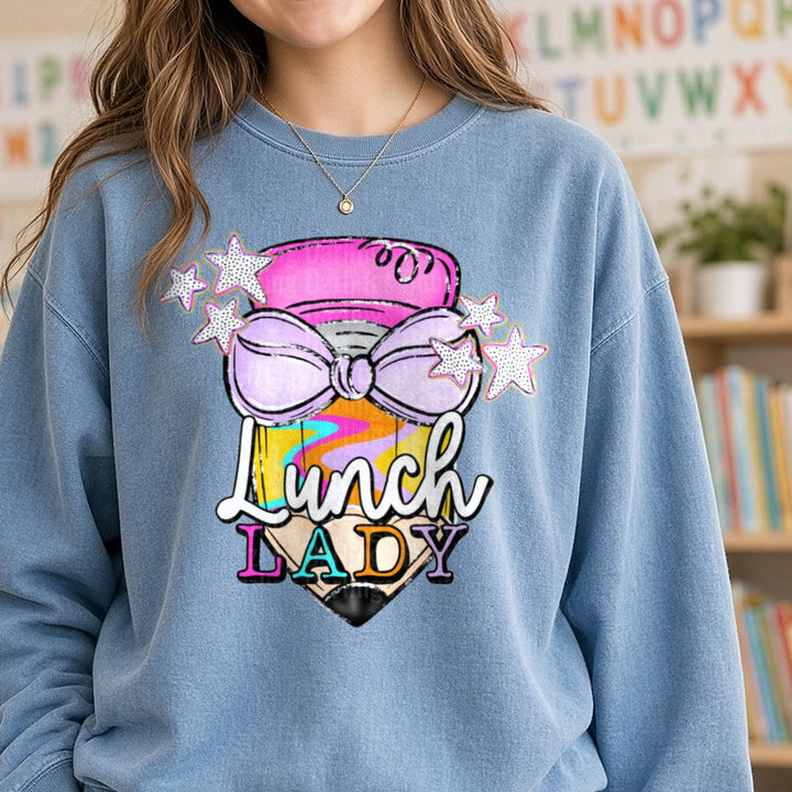 Lunch Lady Pencil with Purple Bow and Colorful Stars DTF transfer shown on a Comfort Colors sweatshirt