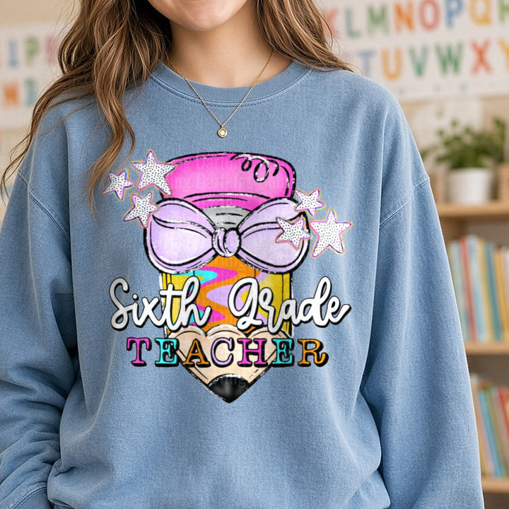 Sixth Grade Teacher Pencil with Bow and Stars DTF transfer shown on a Comfort Colors sweatshirt
