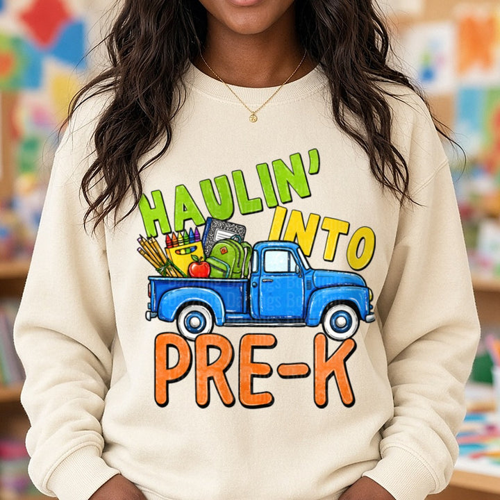 Haulin' Into Pre-K Vintage Blue Truck Back to School DTF transfer shown on a Comfort Colors sweatshirt