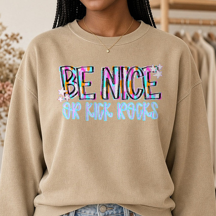 Be Nice Or Kick Rocks Bold Colorful Retro Stars Design DTF transfer shown on a Comfort Colors sweatshirt
