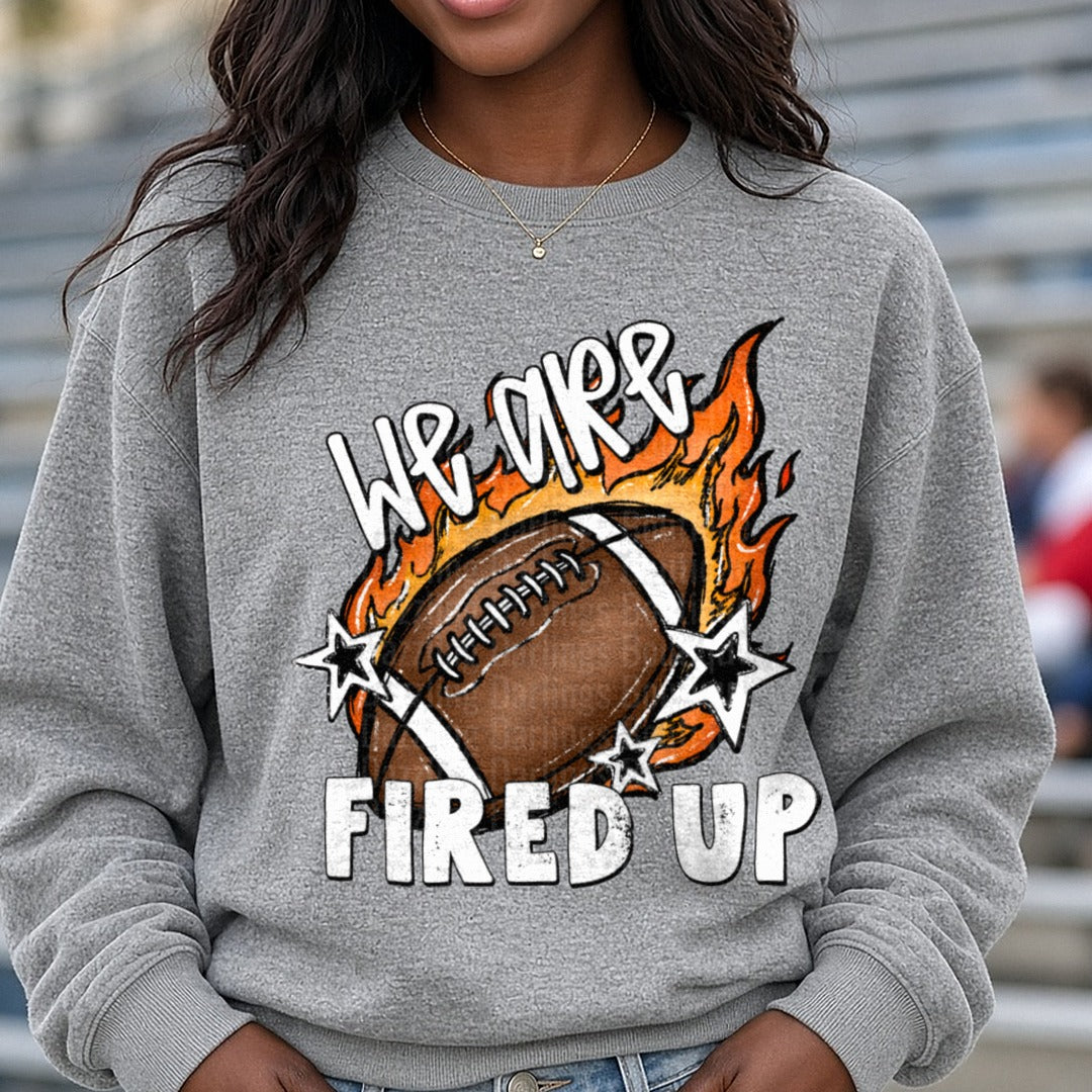 We Are Fired Up Flaming Football Stars Design DTF transfer shown on a Comfort Colors sweatshirt