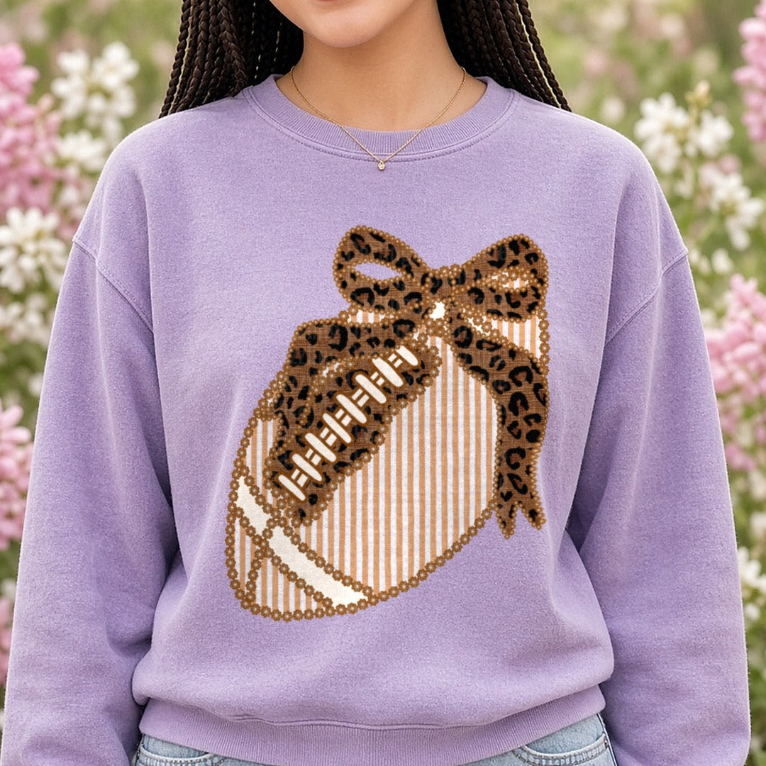 Leopard Print Striped Football with Bow Floral Border DTF transfer shown on a Comfort Colors sweatshirt