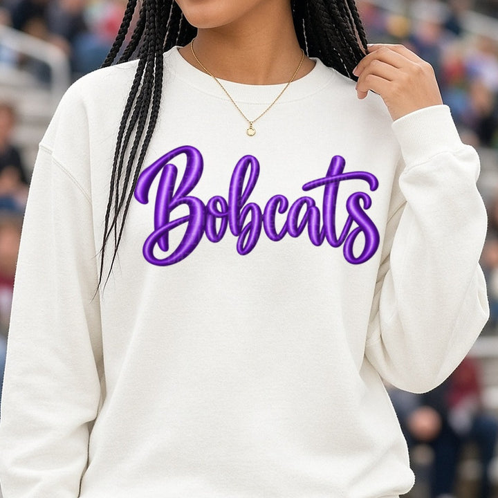 Bobcats Purple Puff Script Lettering Team Name DTF transfer shown on a Comfort Colors sweatshirt