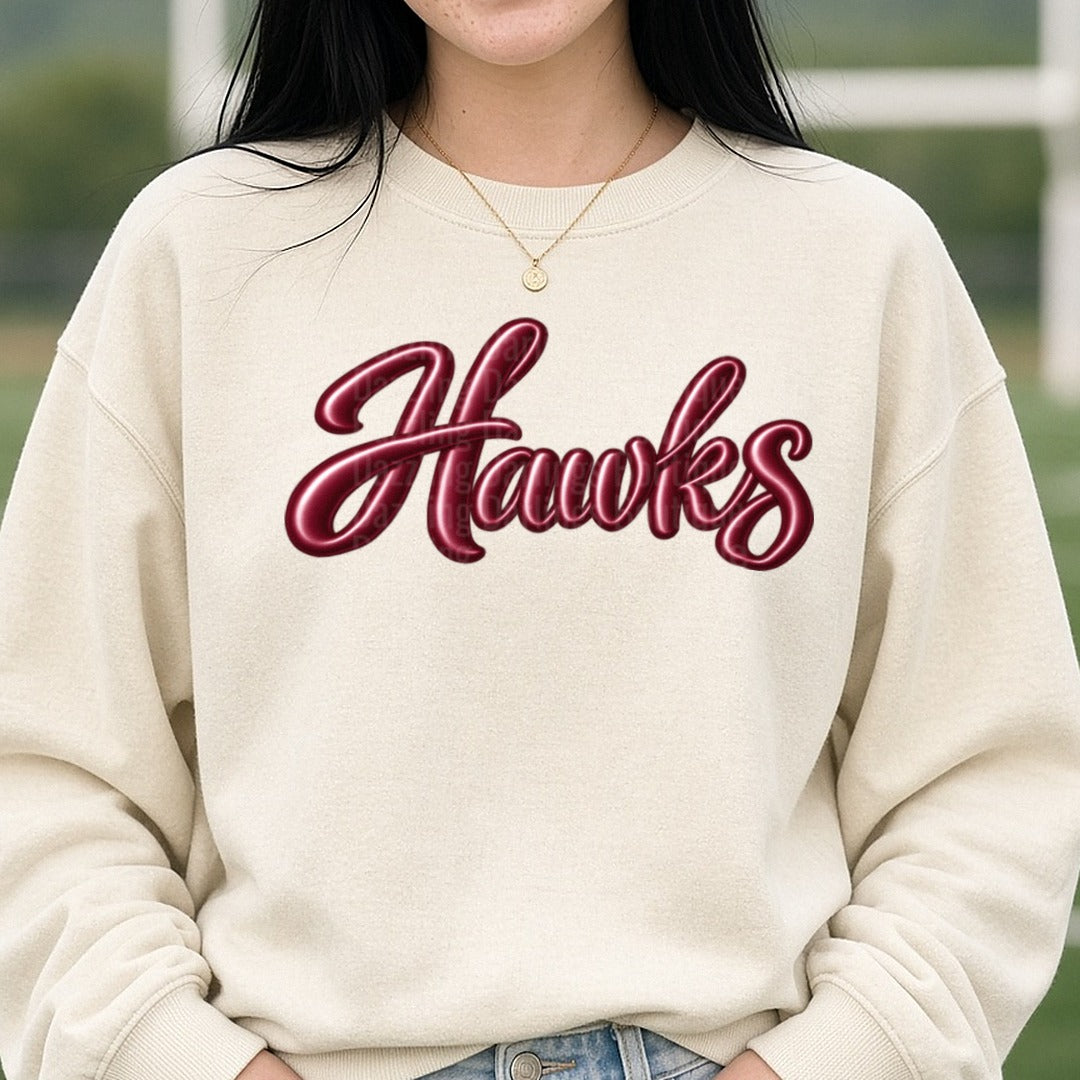 Hawks Glossy Maroon Script Lettering DTF transfer shown on a Comfort Colors sweatshirt