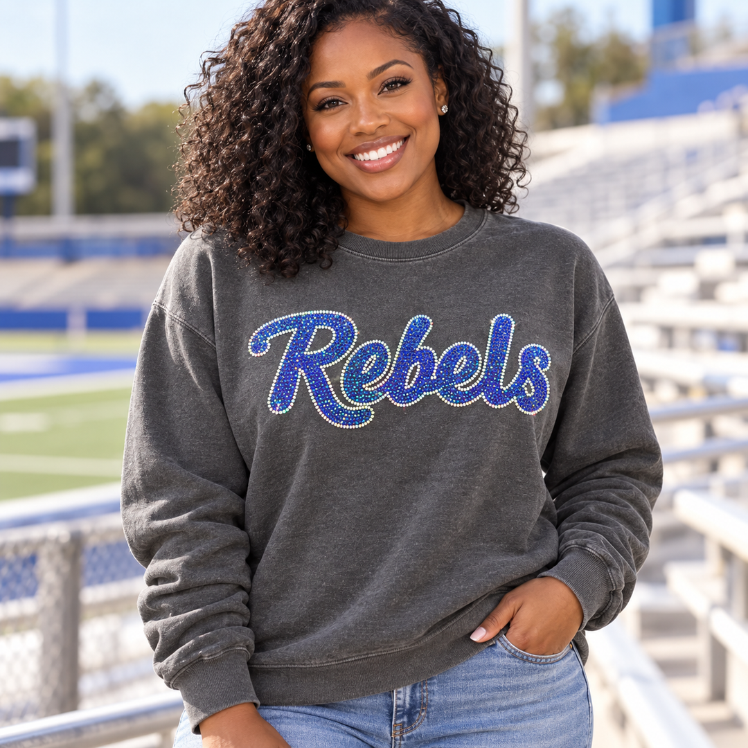 Mockup of royal blue spangle bling "Rebels" script transfer on a charcoal sweatshirt